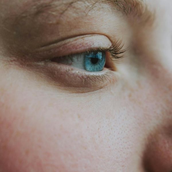 Close-up of a person taking a deep calm breath with eyes closed.